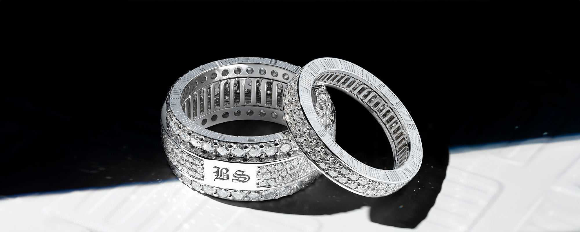 Customised diamond rings by MJ Jones with engraved initials, showcasing luxury craftsmanship and personalisation. These white gold rings feature pave-set diamonds, offering elegance and exclusivity for those seeking bespoke fine jewellery. Ideal for high-end jewellery lovers looking for unique, personalised pieces.