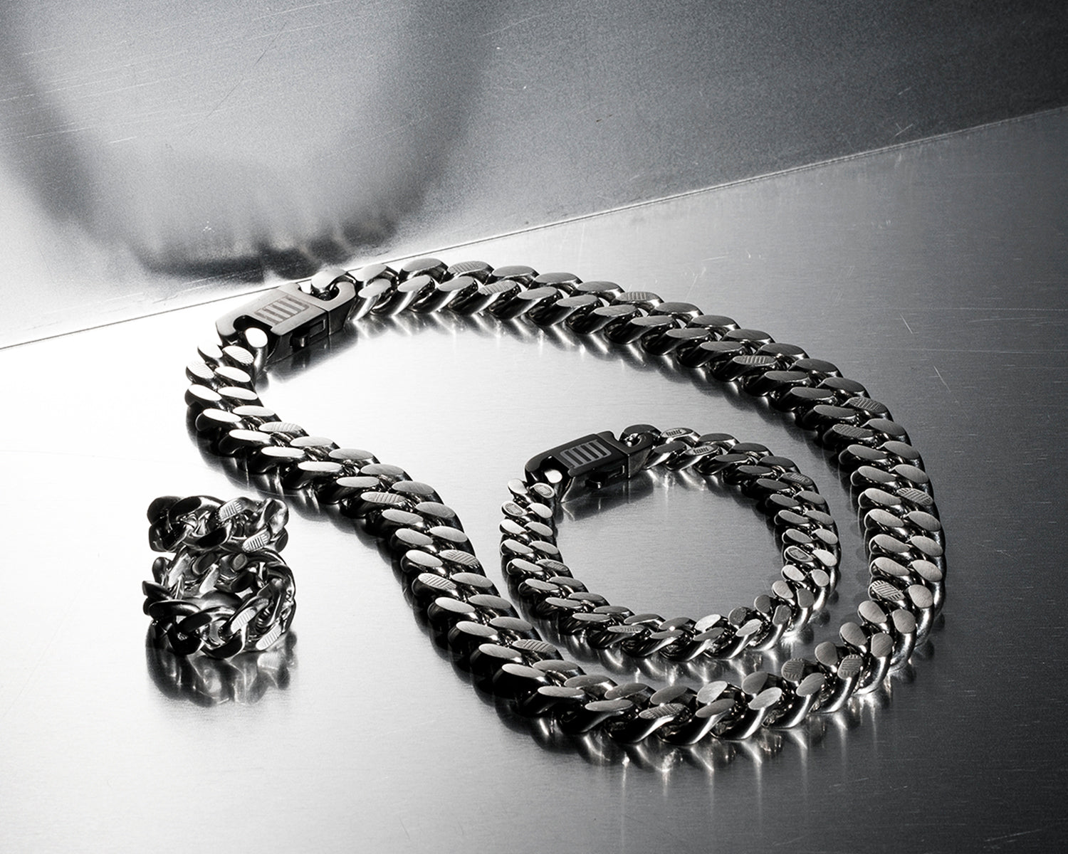 Luxury stainless steel chain necklace, bracelet, and ring set by MJ Jones, featuring bold, high-polish links for a modern, statement look. Ideal for those seeking durable, high-quality jewellery with a contemporary edge, perfect for both everyday wear and special occasions.